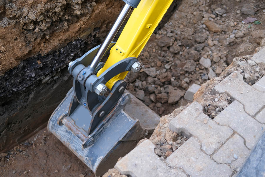 Excavator,Bucket,Digs,Earth,In,Trench,On,Street,,Concept,Of