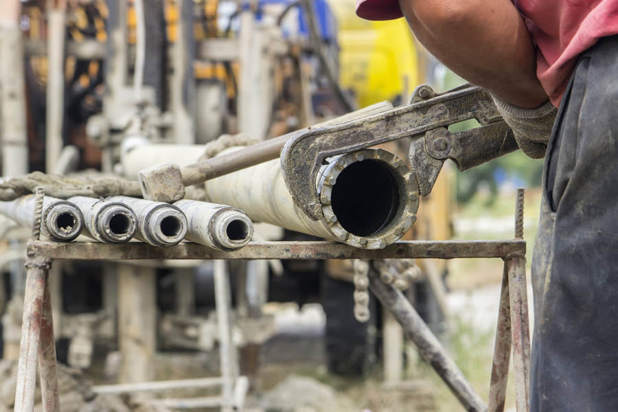 Worker,Hands,With,Big,Monkey,Wrench,Install,A,Drilling,Bit